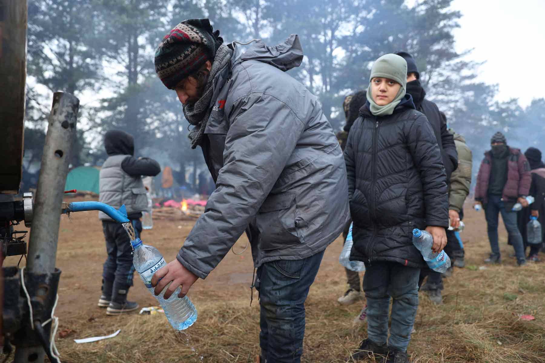 Belarus, 2021 Migrants collect drinking water at the Polish-Belarus border, near Grodno